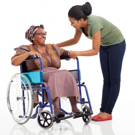 Woman helping older woman in wheelchair